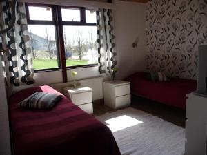 a bedroom with a bed and a window at Hotel Hanhi in Lapinjärvi +12 photos