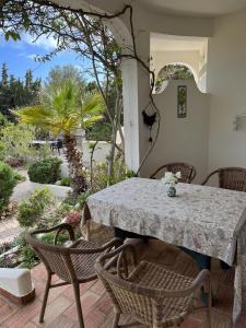 a table and chairs on a patio at 233 Casa Galo Verde Apartments in Porches