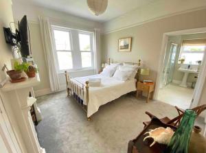 a bedroom with a bed and a large window at Hedgebank in Exmouth