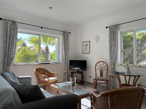 a living room with a couch and a table at 233 Casa Galo Verde Apartments in Porches