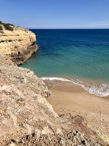 a view of a beach with rocks and the ocean at 233 Casa Galo Verde Apartments in Porches