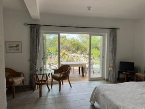 a bedroom with a bed and a table and a patio at 233 Casa Galo Verde Apartments in Porches