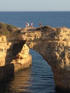 a group of people standing on a cliff over the ocean at 233 Casa Galo Verde Apartments in Porches