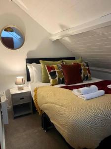 a bedroom with a bed and a mirror on the wall at Church Heights by Flying Stays in Pontypool