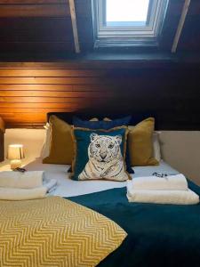 a bedroom with a bed with a tiger pillow on it at Church Heights by Flying Stays in Pontypool