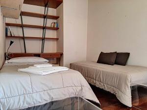 Posteľ alebo postele v izbe v ubytovaní Ospitaci Appartamenti San Salvatore
