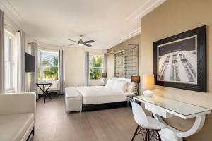 a living room with a white couch and a table at Waldorf Towers South Beach in Miami Beach