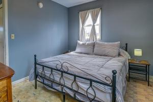 a blue bedroom with a bed and a window at Upstate New York Vacation Rental Near Cooperstown! in Cherry Valley