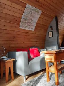 a living room with a couch and a table at Coe Pod, West Highland Way Holidays in Kinlochleven
