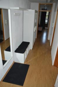 a hallway of an office with a bench and a mirror at Ferienwohnung Mittelbiberach in Mittelbiberach