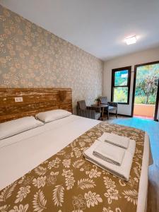 a bedroom with a large bed in a room at Pousada Vila Tamarindo Eco Lodge in Florianópolis