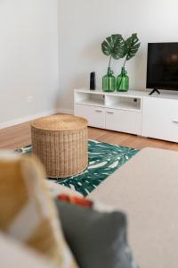 a living room with a couch and a tv at Solar da Fontinha by An Island Apart in Santa Cruz