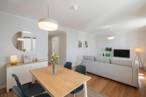 a living room with a table and a couch at Solar da Fontinha by An Island Apart in Santa Cruz +21 photos