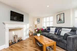 a living room with a couch and a fireplace at Luxury apartment in the centre of Winchester in Winchester