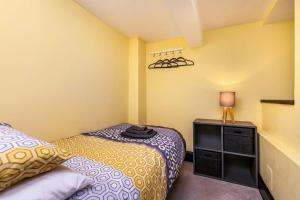 a small bedroom with a bed and a lamp at Luxury apartment in the centre of Winchester in Winchester