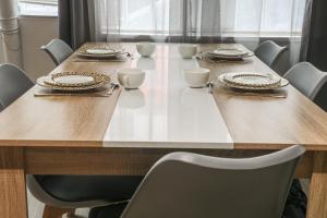 a table with chairs and plates and dishes on it at Comfortable 1br in the 11th district of Paris - Welkeys in Paris