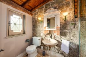 a bathroom with a toilet and a sink at Roman Oasis Villa in Ciampino