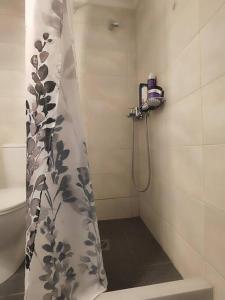 a shower curtain in a bathroom with a toilet at Two-storey house in Kardamyla in Mármaron