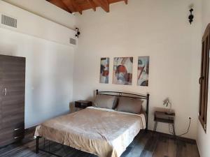 a bedroom with a bed in a white wall at Seafront two-storey house in Kardamyla in Mármaron