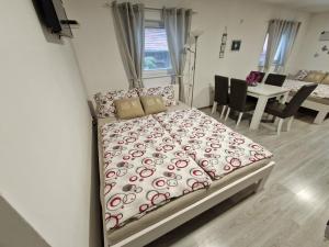 1 Schlafzimmer mit einem Bett und einem Esszimmer in der Unterkunft Guesthouse Ella in Slunj