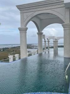 a large swimming pool with water in a building at Hue - Modern Apt with Vietnamese inspired interior in Hue