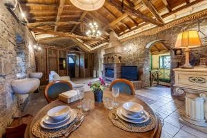 a dining room with a table and a fireplace at Roman Oasis Villa in Ciampino