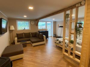 a living room with a couch and a bed at Apartma LIMA in Mozirje