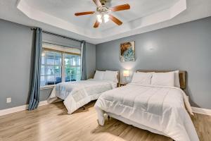 a bedroom with two beds and a ceiling fan at Near Hospital and Downtown- Lodging on Leghorn in Savannah