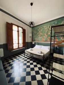 a bedroom with a bed and a checkered floor at Blom apartments in Pisa +72 photos