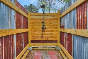 a wooden fence with a gate with a camera on it at Khushatta Hills Ranch Glamping - Mom Mollie in Coldspring