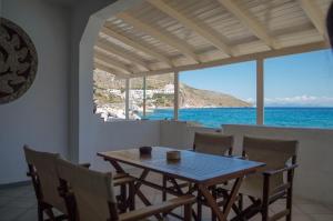 a dining room with a table and a view of the ocean at Sunrise Apartments in Livadia