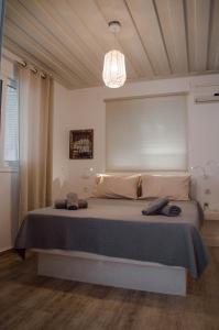 a bedroom with a large bed with a chandelier at Sunrise Apartments in Livadia