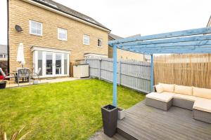 a patio with a couch on a wooden deck at Cobbeydale room in Silsden