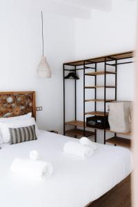 a bedroom with a bed with two white towels on it at Outsite Ibiza in Es Cana