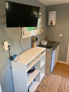 a small kitchen with a desk with a television on it at Tiny-Ferienwohnung Hellerau 2 in Dresden