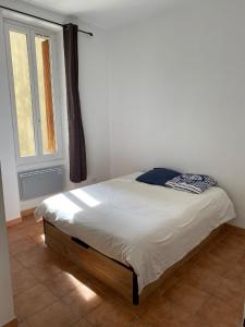 a bed sitting in a room with a window at T2 vue mer CATALANS - NETFLIX - VELODROME in Marseille