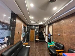 a man standing in a room with a couch at THE PARK AVENUE HOTEL - Business Class Hotel Near Central Railway Station Chennai Periyamet in Chennai