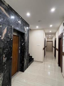a hallway in a building with a large stone wall at THE PARK AVENUE HOTEL - Business Class Hotel Near Central Railway Station Chennai Periyamet in Chennai