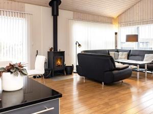 a living room with a couch and a fireplace at 6 person holiday home in Hirtshals in Hirtshals