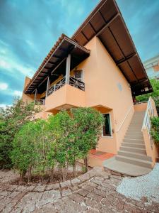 a house with a staircase in front of it at Pousada Vila Tamarindo Eco Lodge in Florianópolis