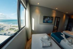 Postel nebo postele na pokoji v ubytování Hotel Água de Coco