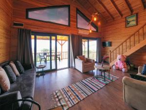 a living room with a teddy bear sitting on the floor at Koruwoodenhouse in Gazipasa
