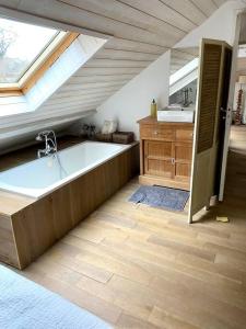 a bathroom with a large bath tub and a sink at Magnifique villa golf du Touquet in Le Touquet-Paris-Plage