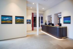 a lobby with a reception desk and paintings on the wall at Hotel Alte Post in Konstanz
