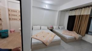 Postel nebo postele na pokoji v ubytování Hotel Aashirwad