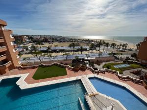 an aerial view of a resort with a swimming pool and the beach at Mirador de Sanlucar 9 in Sanlúcar de Barrameda