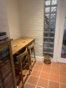 a room with a wooden table with chairs and wine bottles at Villa Paulina Family suite in Langebaan