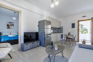 a living room with a refrigerator and a kitchen at Lina apartments in Skopelos Town