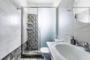 a bathroom with a sink and a toilet and a shower at Lina apartments in Skopelos Town +29 photos