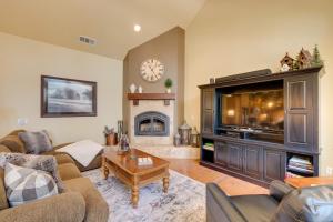 a living room with a large television and a fireplace at Secluded Pioneer Escape with Furnished Decks and Grill in Pioneer